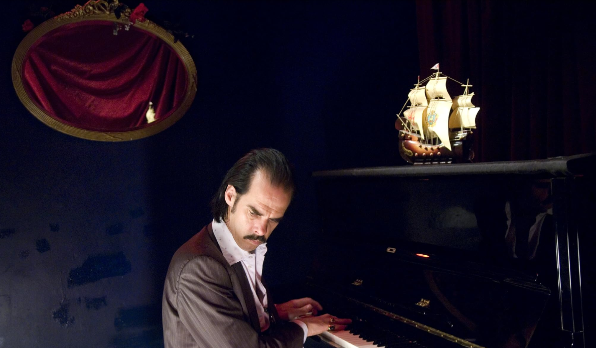 Nick Cave seated at a piano from Nick Cave: Abusing the Muse (2008)